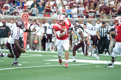 Quarterback Garrett Gilbert carries the ball against A&M in 48-3 loss Sept. 15. The Aggies limited Gilbert to 203 yards passing on 49 attempts.