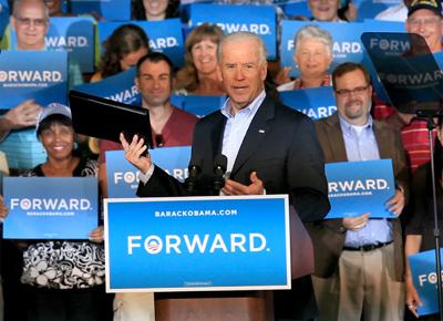 Vice President Joe Biden holds up a binder while remarking on Republican presidential candidate former Massachusetts Gov. Mitt Romney’s recent debate gaffe during a visit to Ketterlinus Gymnasium in St. Augustine, Fla. on Saturday.
