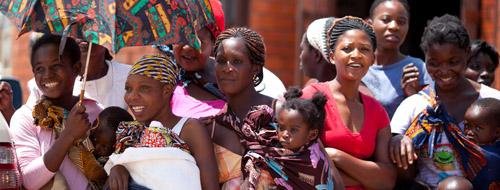 Mothers wait with their children to greet President and Mrs. Bush at the George Urbin Health Center in Lusaka, Zambia.