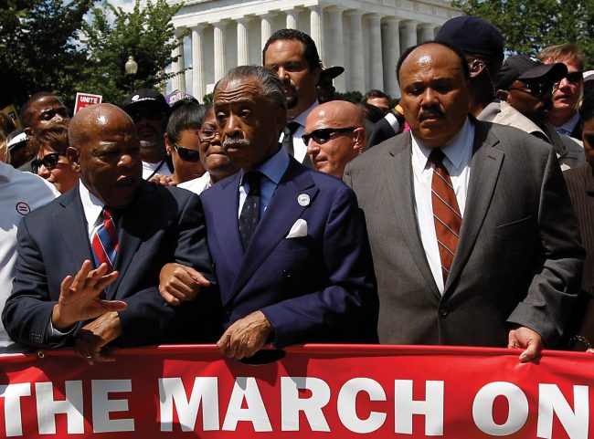 From left, Rep. John Lewis, D-Ga., Rev. Al Sharpton, and Martin Luther King, III, start the march towards the Martin Luther King Jr. Memorial after the rally at the Lincoln Memorial, commemorating the 50th anniversary of the 1963 March on Washington Saturday, Aug. 24, 2013. (Courtesy of AP)