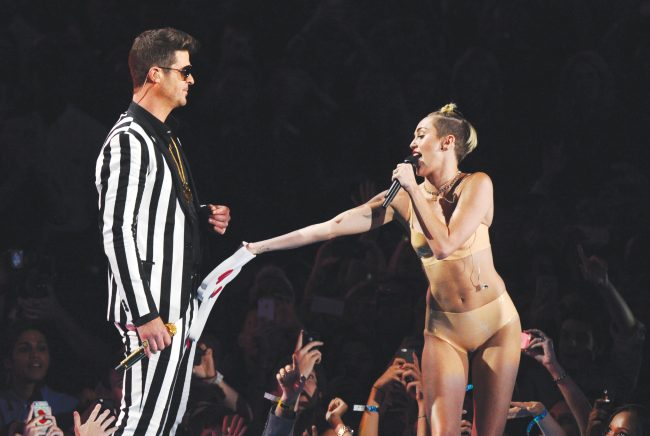Singers Robin Thicke, left, and Miley Cyrus perform “Blurred Lines” at the MTV Video Music Awards in the New York borough of Brooklyn. Cyrus said in an interview clip that she doesn’t listen to the negative comments regarding her performance on the MTV Video Music Awards. (Courtesy of AP)
