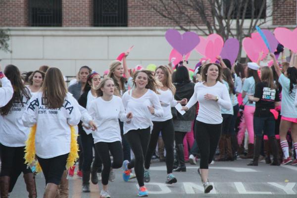 Students run to their new sorority houses after receiving their official bid cards following rush week in January. (CHRISTOPHER SAUL / The Daily Campus)