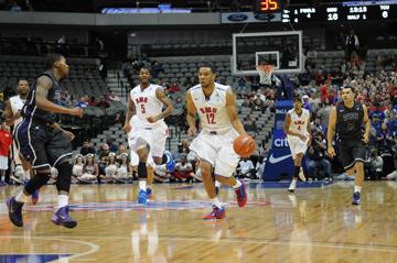 SMU guard Nick Russell (12) and forward Markus Kennedy (5) bring the ball up the court against Texas Christian University at the American Airlines Center Nov. 8. The Mustangs beat the Horned Frogs 69-61. (RYAN MILLER / The Daily Campus)