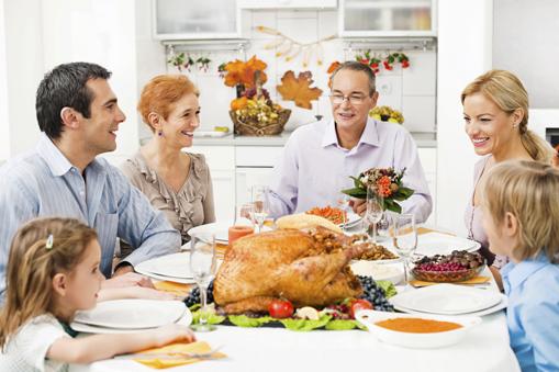 Happy extended family having family lunch on a Thanksgiving day. (Courtesy of publicnewshealthwire.org)