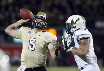 Central Florida quarterback Blake Bortles (5) is pressured by South Florida defensive lineman Aaron Lynch (19) during the first half of an NCAA college football game on Friday, Nov. 29, 2013, in Orlando, Fla. (AP Photo/Reinhold Matay
