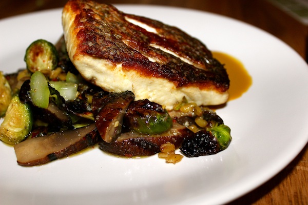 The roasted red fish with a spicy umami sauce, roasted brussels sprouts, portobello mushrooms and freekeh was a clean and simple fish entree. (MALLORY ASHCRAFT/The Daily Campus)