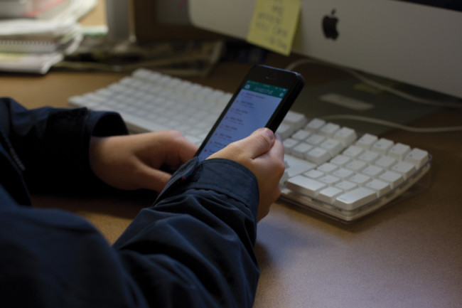 An SMU student opens a snap on her smart phone using the Snapchat application.Photo credit: Ellen Smith