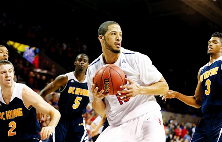 SMU's Cannen Cunningham (15) looks to pass the ball surrounded by he UC-Irvine guard Chris McNealy (5) and forward Will Davis II (3) March 29, 2014. (Courtesy of AP)