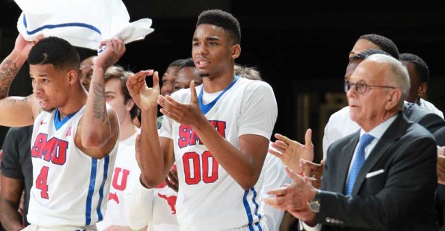 December 5, 2014; Dallas, TX; SMU Mustangs forward Ben Moore #00, teammates, and head coach Larry Brown cheer on the team against the Wyoming Cowboys at Moody Coliseum.  Photo by Vladimir Cherry