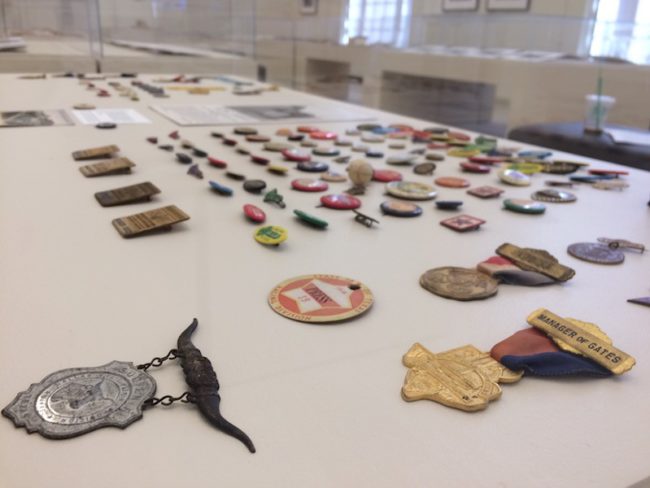 Dozens of collectible pins from the Fair over the years are displayed, including police badges. Photo credit: Jacquelyn Elias