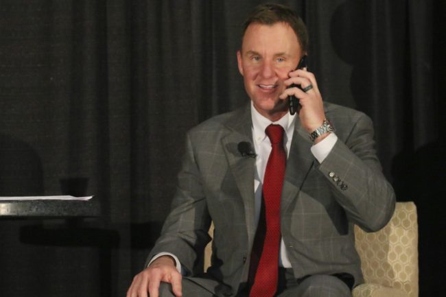 SMU head football coach Chad Morris takes a phone call from a recruit during a National Signing Day Celebration luncheon. Photo credit: Mollie Mayfield
