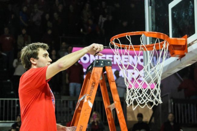 SMU senior guard Jonathan Wilfong cuts down the nets after SMU won the outright AAC title with a 103-62 win vs. Memphis on March 4, 2017. Photo credit: Mollie Mayfield