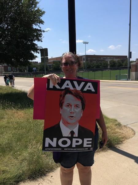 Protestor holds KAVANOPE sign outside of the George W. Bush Presidential Center Photo credit: Nusaiba Mizan