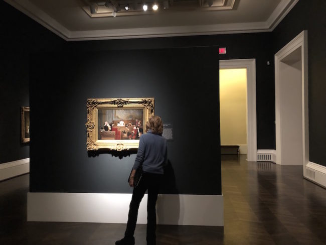 A gallery talk attendee examines “Trial of Pierrot,” by Jehan Georges Vibert Photo credit: Allison Sheehan