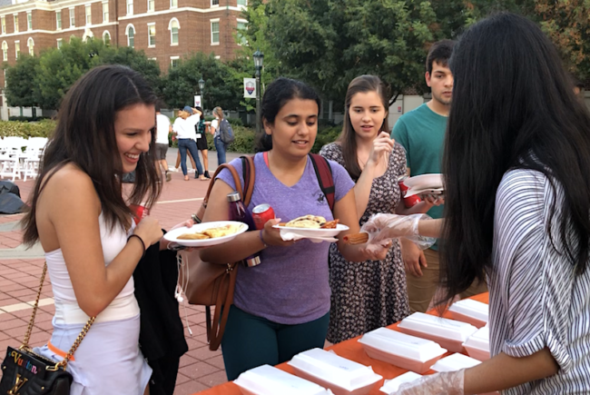 Students line up for free churros, pupusas, tamales, and more at Viva America on Wed., Sept. 18, 2019. Photo credit: Cristin Espinosa
