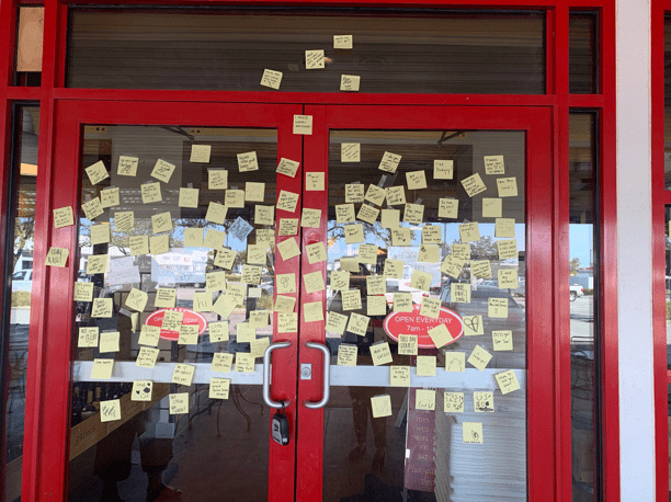 Loyal Eatzies’ customers post positive notes on the doors of the store while it was closed. Photo credit: May Bolte