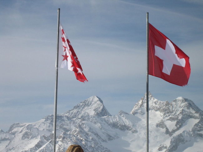 Swiss flags on the mountains. Photo credit: Creative Commons