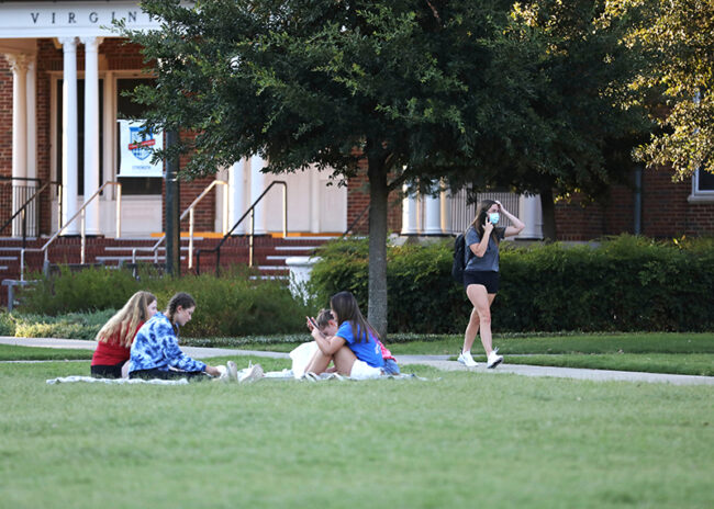 The Fall 2020 Stampede (first-year orientation) was switched to an online event last-minute. Stampede groups bonded, then, through outdoor lawn games and meals. In the MHPS Quad, students combined orientation with the outdoor bonding by watching the Kickoff livestream from their phones and from park benches. Photo credit: Ash Thye