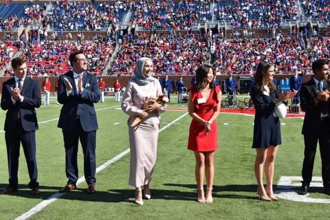 Candidates for Homecoming Royalty stand near the 50-yard line during halftime of the SMU Homecoming football game. Photo credit: Student Foundation