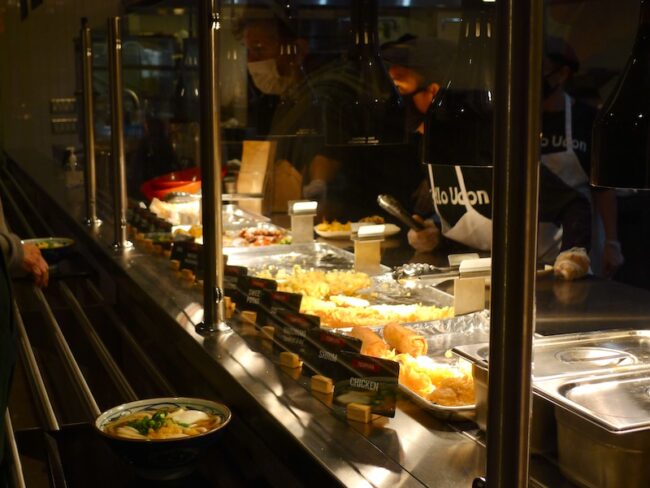 Marugame diners choose from a selection of Japanese street foods after receiving their udon.