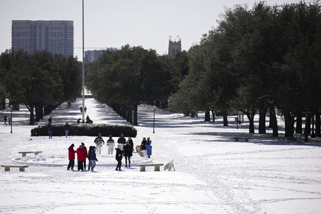 Students take in the snow that covers Dallas Hall lawn. SMU announced earlier in the day that classes are cancelled through at least Tuesday as the state continues to experience rolling power outages. Photo credit: Ash Thye