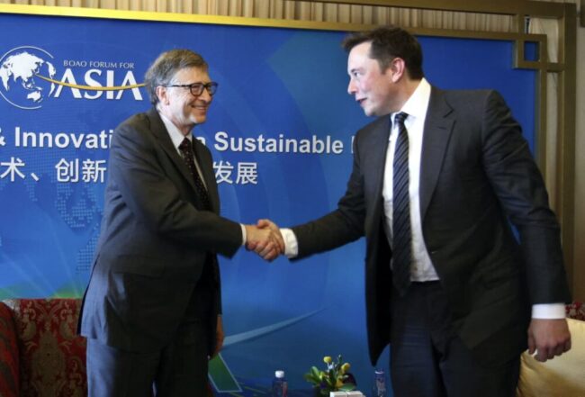 Elon Musk and Bill Gates shake hands at a conference in 2015.