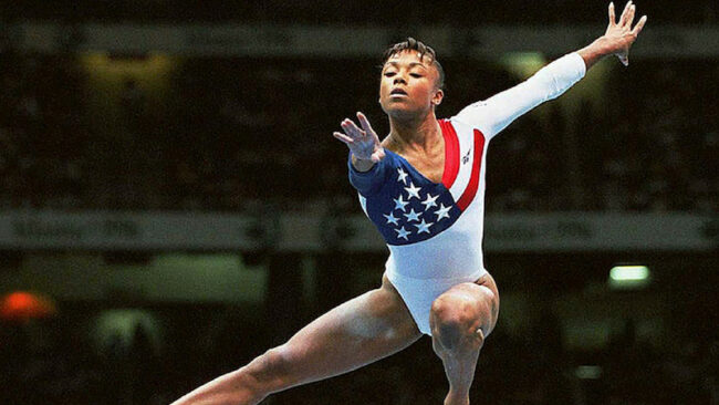 Gymnastics legend Dominique Dawes became the first black woman to win a gold medal in Olympic gymnastics in the 1996 Olympics. She is now a famed motivational speaker and powerful advocate for black women worldwide. Photo Credit: Getty Images