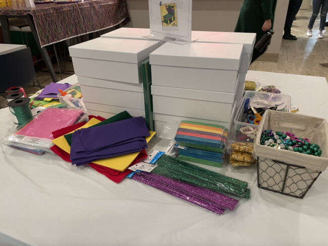 The organization had a station dedicated a table with supplies for guests to build their own Mardi Gras miniature float. Photo credit: Grace Lawrence