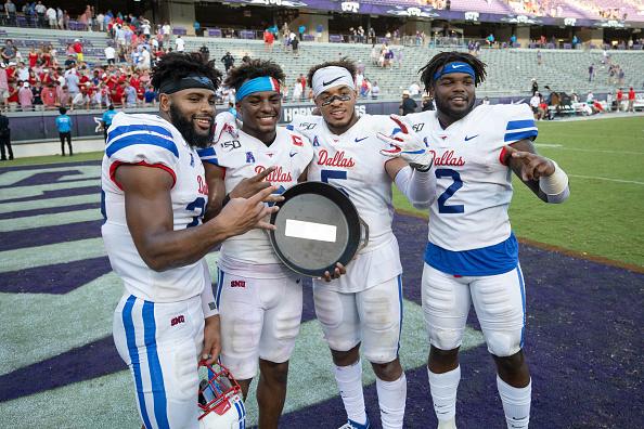 FORT WORTH, TX - SEPTEMBER 21: SMU Mustangs safety Rodney Clemons (#23), SMU Mustangs wide receiver James Proche (#3), SMU Mustangs running back Xavier Jones (#5), and SMU Mustangs running back KeMon Freeman (#2) celebrate with the Iron Skillet during the college football game between the SMU Mustangs and TCU Horned Frogs on September 21, 2019 at Amon G. Carter Stadium in Fort Worth, TX.  (Photo by Matthew Visinsky/Icon Sportswire via Getty Images)