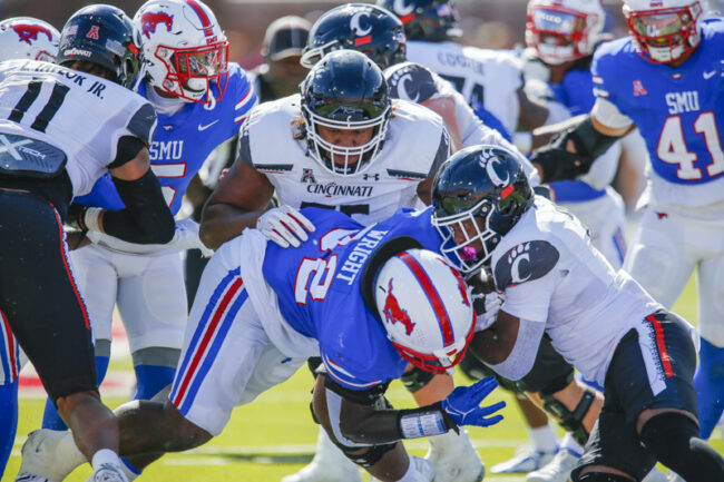 SMU defensive tackle Stephon Wright is brought down by Cincinnati players during an NCAA football game at Ford Stadium on Saturday, Oct. 22, 2022 in University Park, Texas. Cincinnati defeated SMU 29-27. (Mark Reese / Photographer)