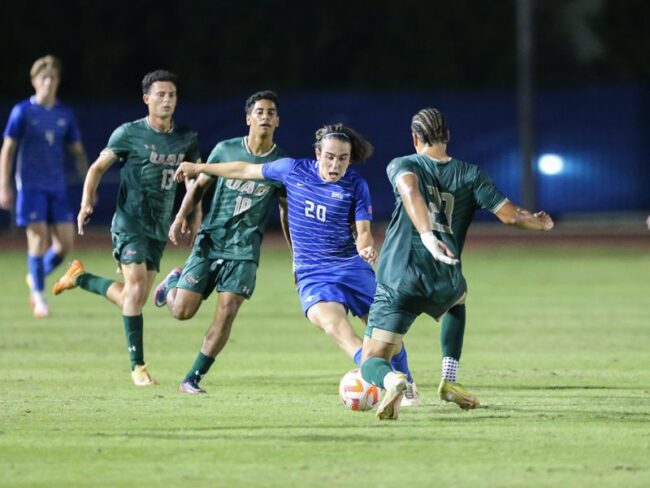 Nikola Djordjevic makes a strong run down the field, eluding several UAB players.