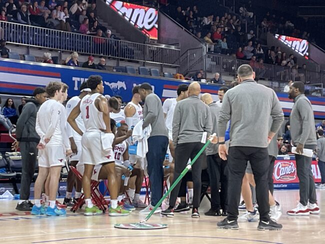 Zhuric Phelps stands with the SMU Basketball team during a timeout in an American Athletic Conference Game against ECU.