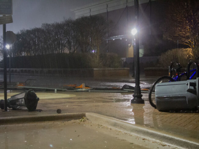 A fallen trashcan and broken light post lay on the ground in front of the Loyd All-Sports Center on SMUs campus during the storm on March 2, 2023. (Kiley Pittman/SMU). Photo credit: Kiley Pittman