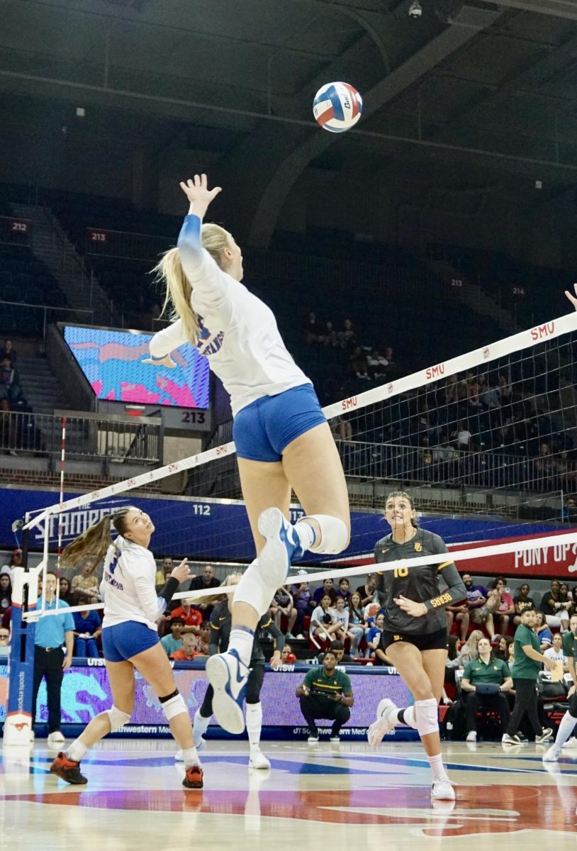 An SMU Volleyball player spikes the ball against Baylor in Moody Coliseum. 
