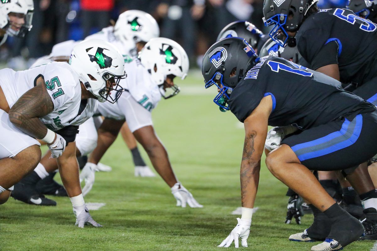 SMU+and+UNT+players+line+up+on+the+turf+at+Ford+Stadium+in+their+Nov.+10+matchup.