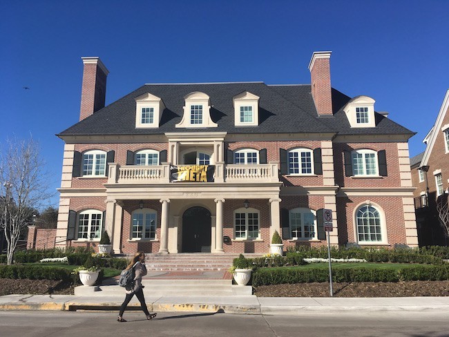 A Thought Theta bid day banner is displayed across the front of the sorority house in 2017.