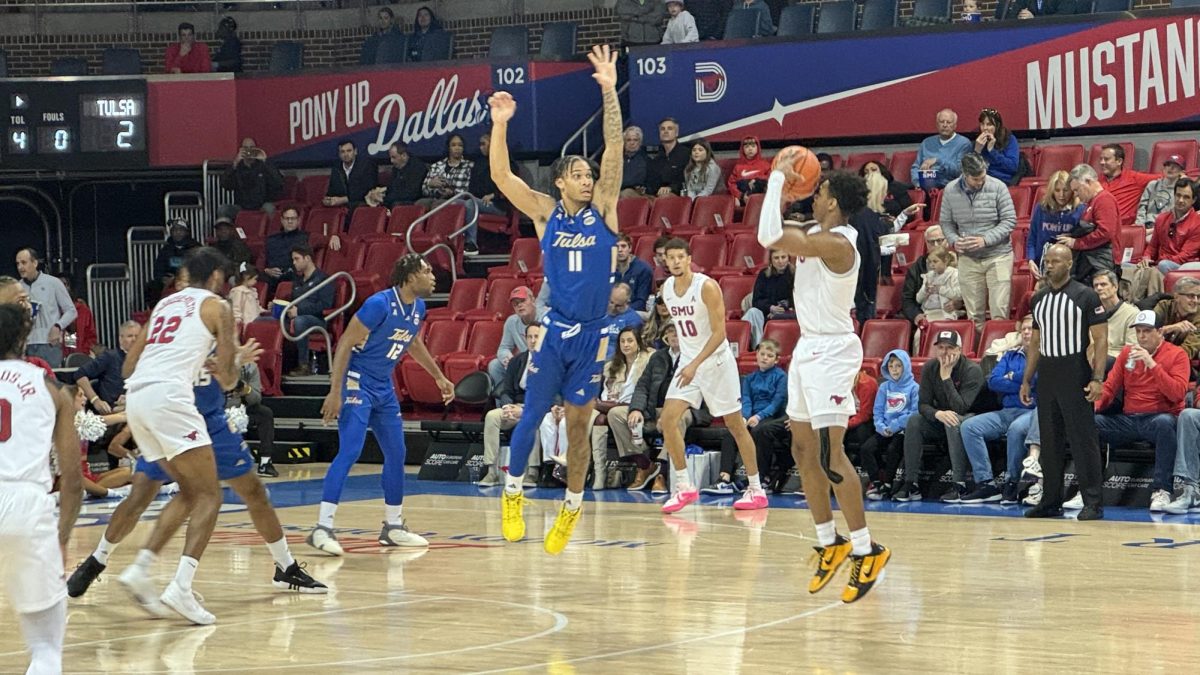 SMU Guard Zhuric Phelps shoots over Tulsa guard Isaiah Barnes for a three-point shot.