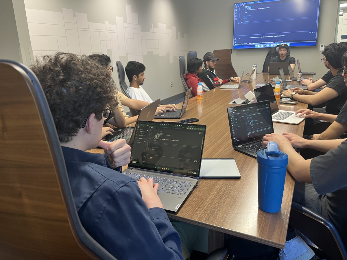 A group of hackers work hard during a workshop.