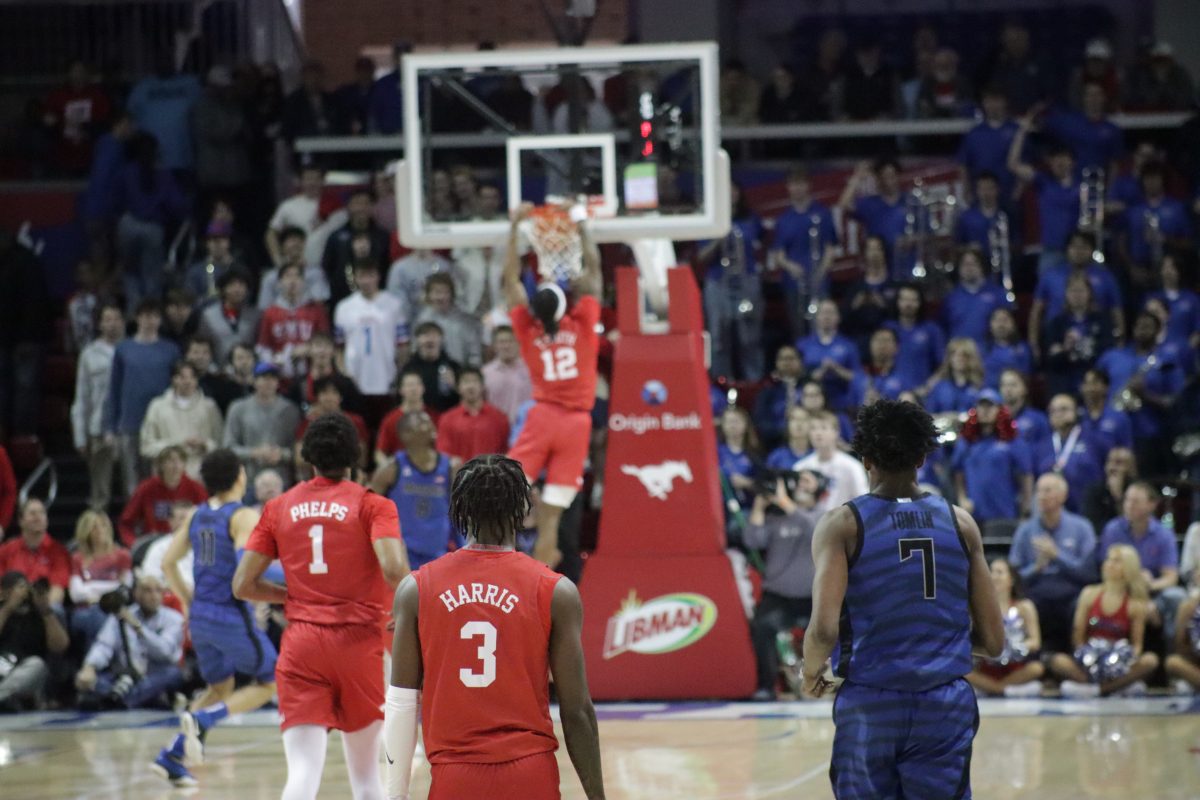 SMU's Tyreek Smith dunks as the Mustangs run up the scoreboard against Memphis in Moody Coliseum. 