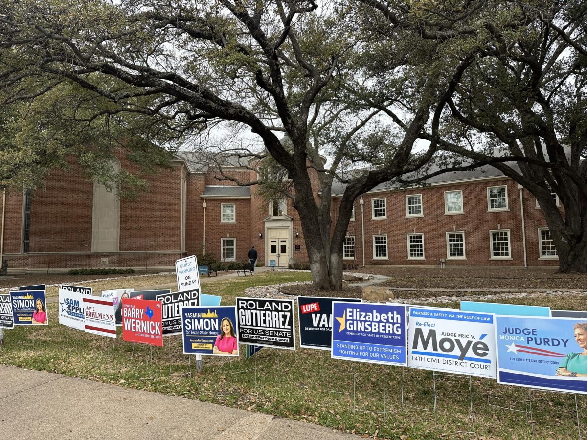 Campaign signs line the sidewalk Feb. 28 in front of United Methodist Church, 4024 Caruth. 