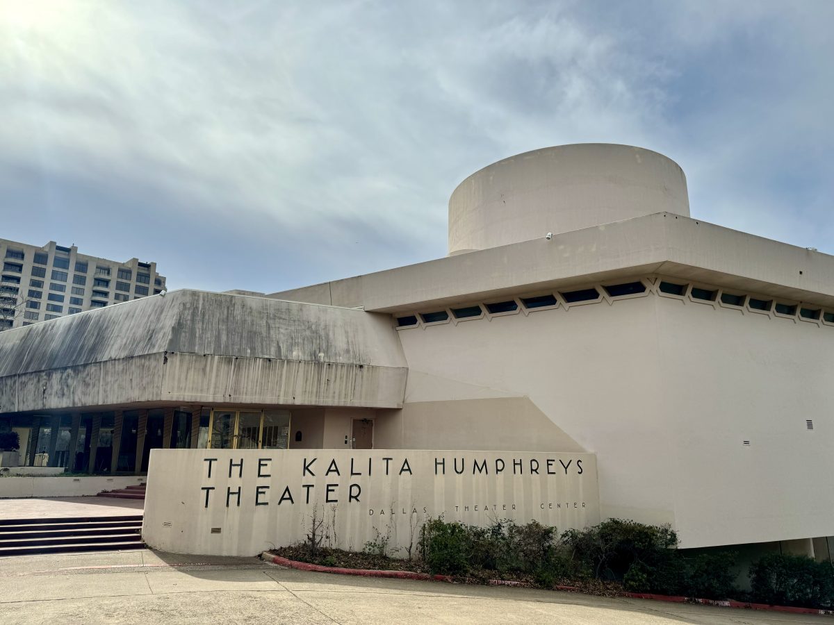 Kalita Humphreys Theater sits in disrepair, tucked between large elm trees.