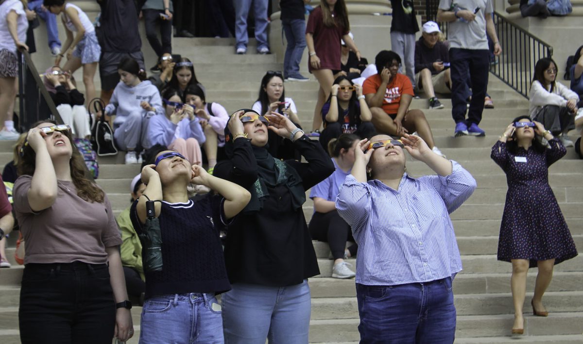 Students, staff, and community members gather to watch the eclipse surpass totality Monday, April 8, 2024 in Dallas, Texas. People set up chairs and blankets as they watch the solar eclipse on Dallas Hall lawn. (©EllaMiller/SMU)
