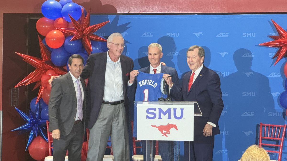 (from left to right) Athletic Director Rick Hart, David Miller, new head coach Andy Enfield, and R. Gerald Turner pose for the cameras with an Enfield SMU basketball jersey.