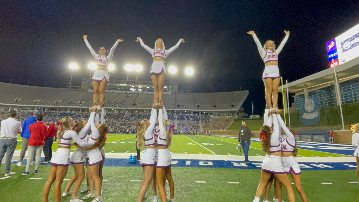 SMU spirit squads supporting the mustang football team on the sidelines of a football game.