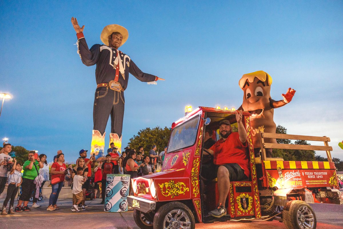 Owner William Fletcher cruises through the State Fair of Texas in the iconic Fletcher’s Corny Dog cart and passes by Big Tex.