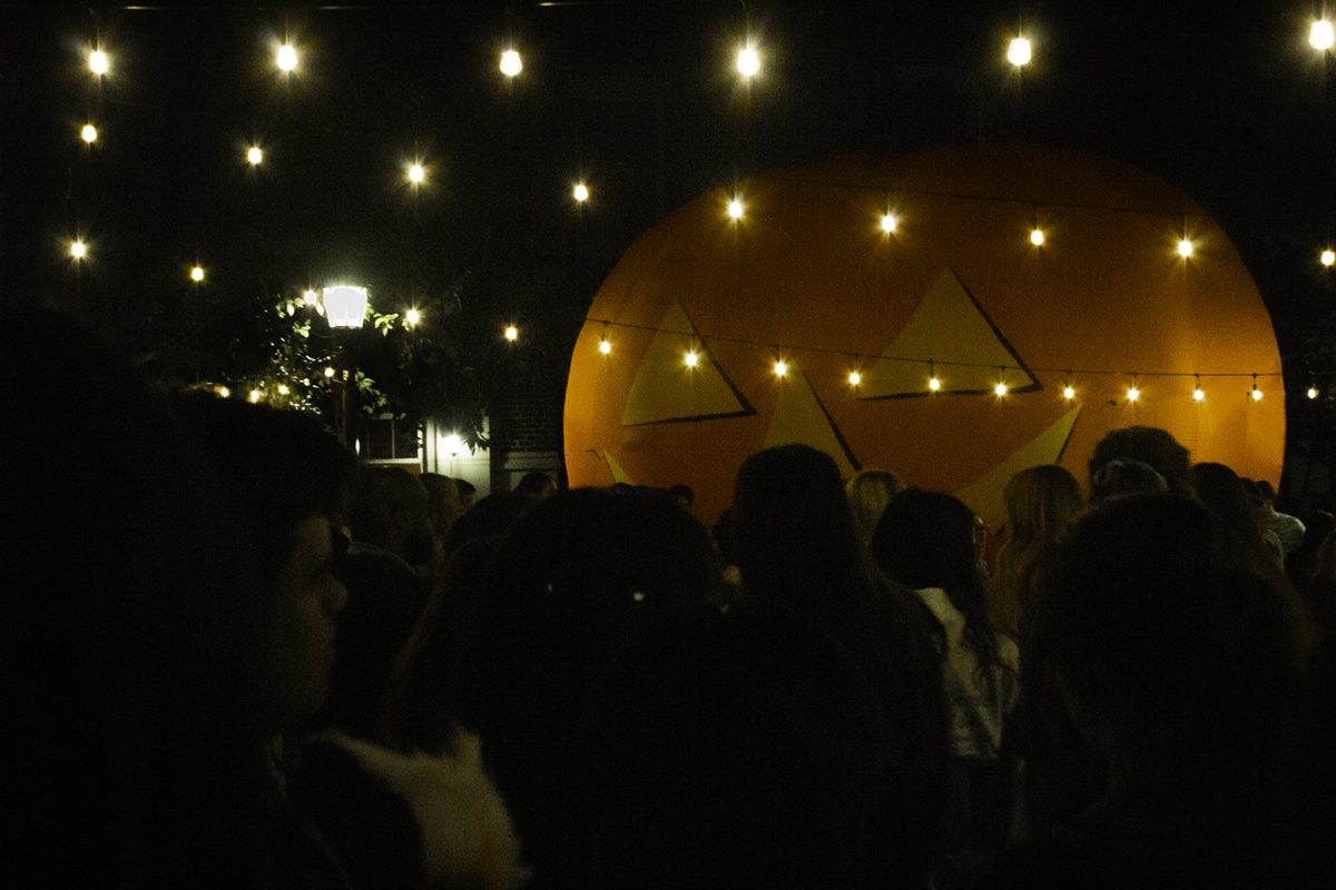 People mingle in front of the inflatable pumpkin at the 2024 Crumpkin event. Dallas, TX, SMU, October 18, 2024.