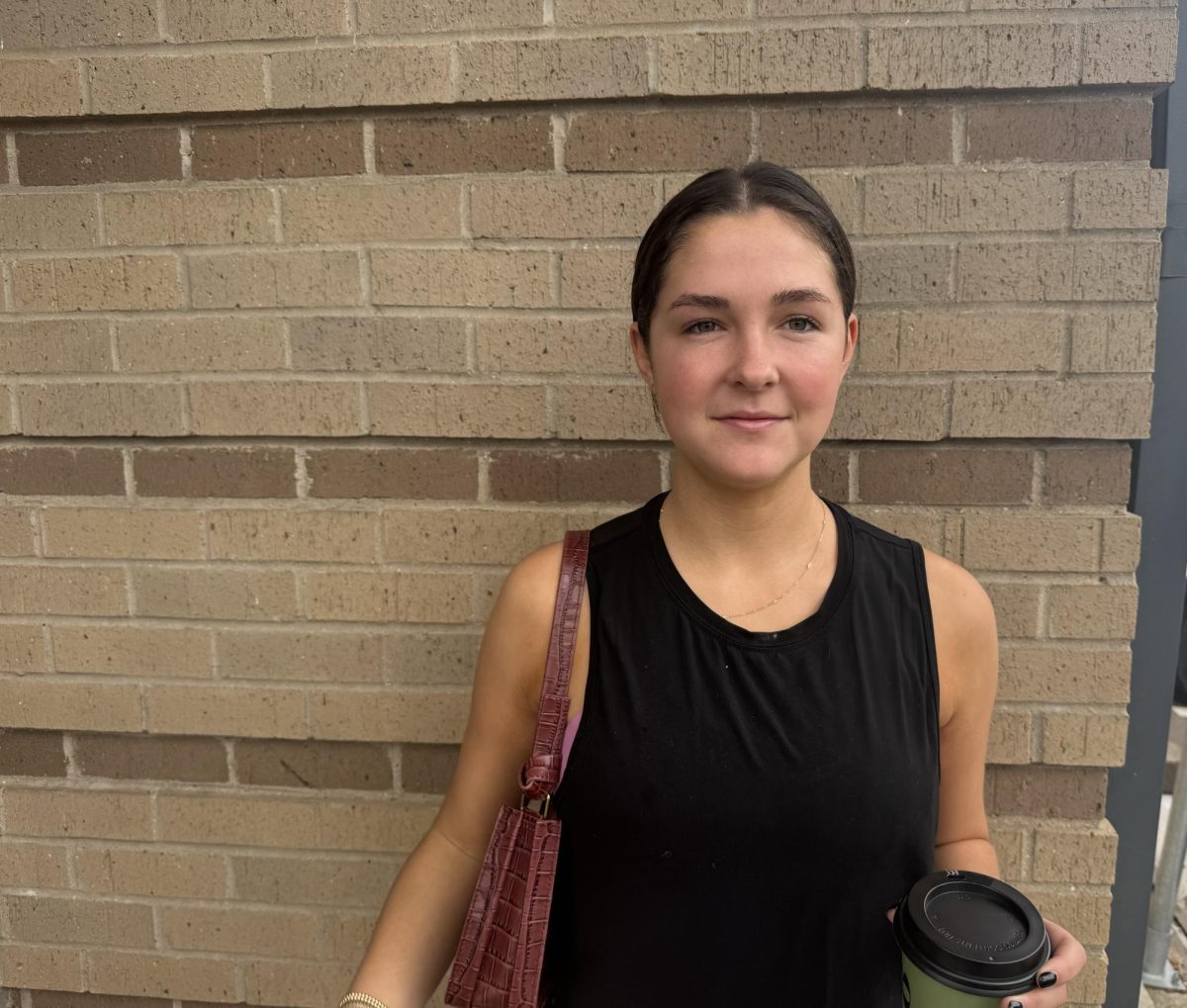 Julia White, 22, stands by the wall after voting to wait for her family to finish.