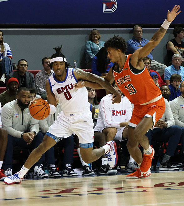 SMU basketball player, B.J. Edwards dribbles the ball while Florida A&M basketball player, Kaleb Washington attempts to block him during the game at Moody Coliseum in Dallas, Texas on November 7, 2024.