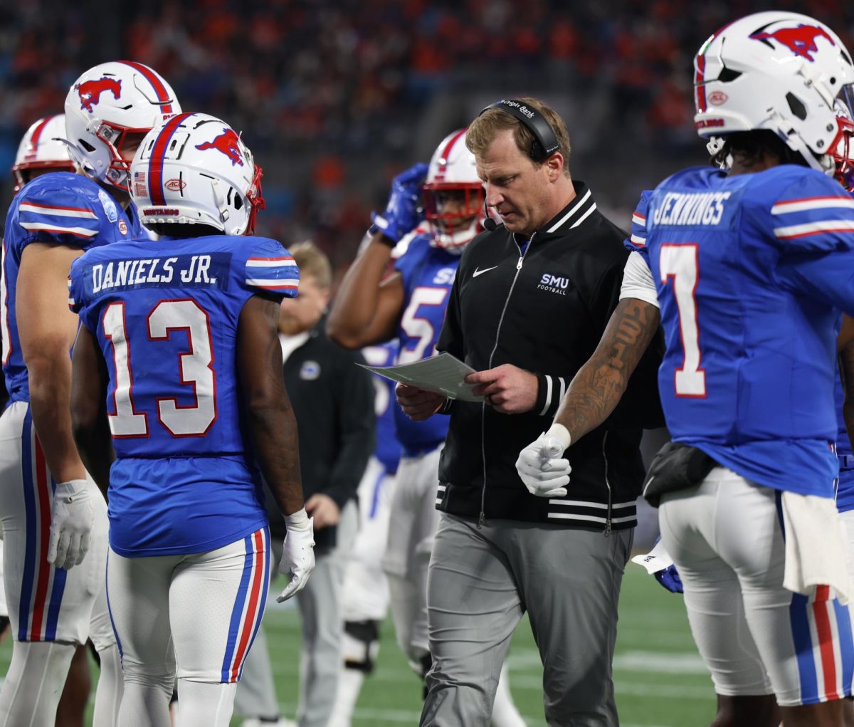 Coach Lashlee talks with his team during a time-out in Charlotte, North Carolina, on December 7, 2024