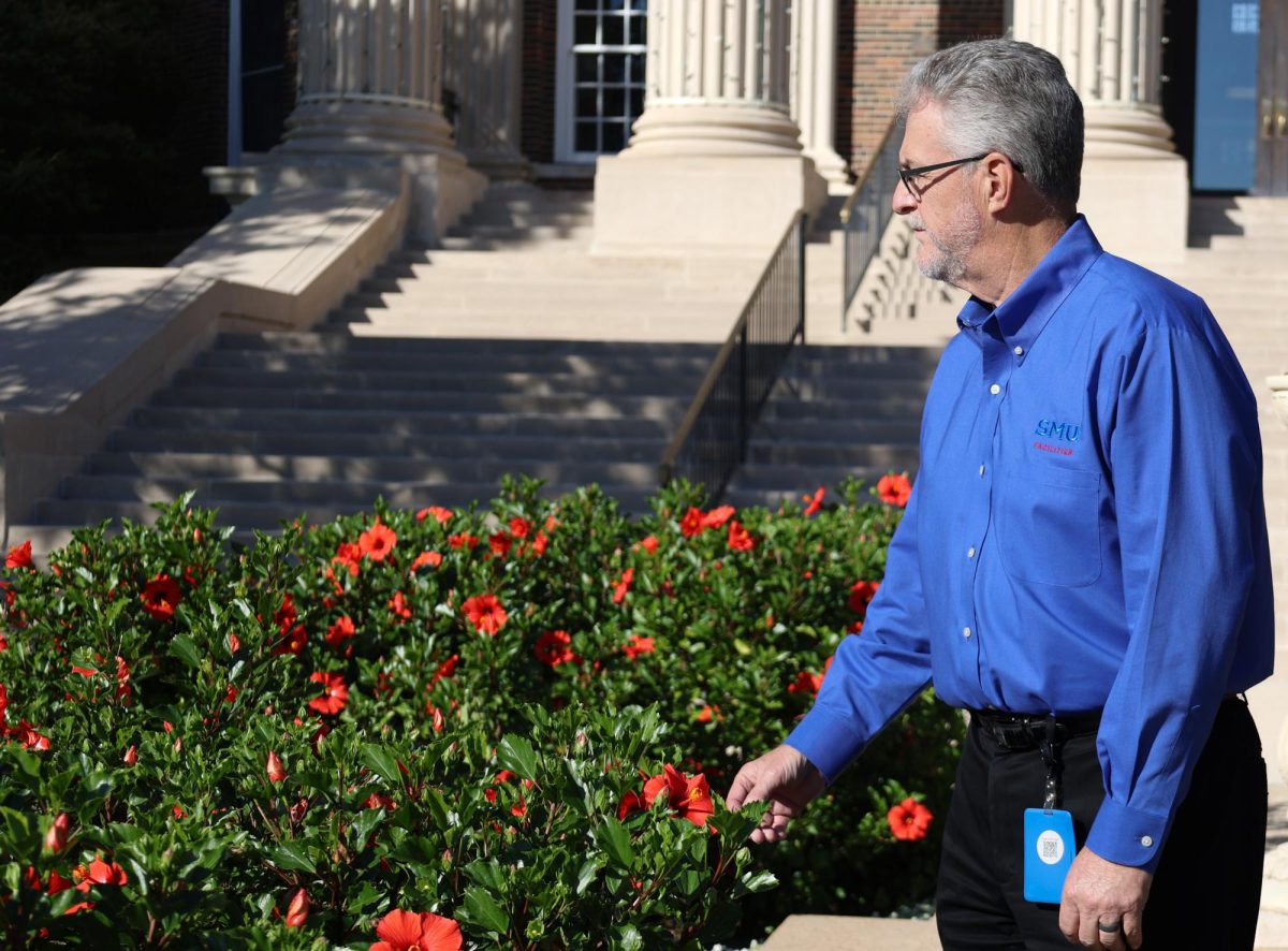 Kevin Dilliard caresses a flower outside Dallas Hall in Dallas, Texas, on November 12, 2024.